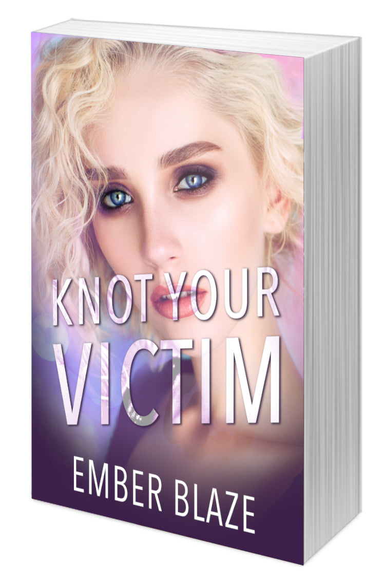 Paperback book cover of 'Knot Your Victim' by Ember Blaze with a woman's face on the cover.